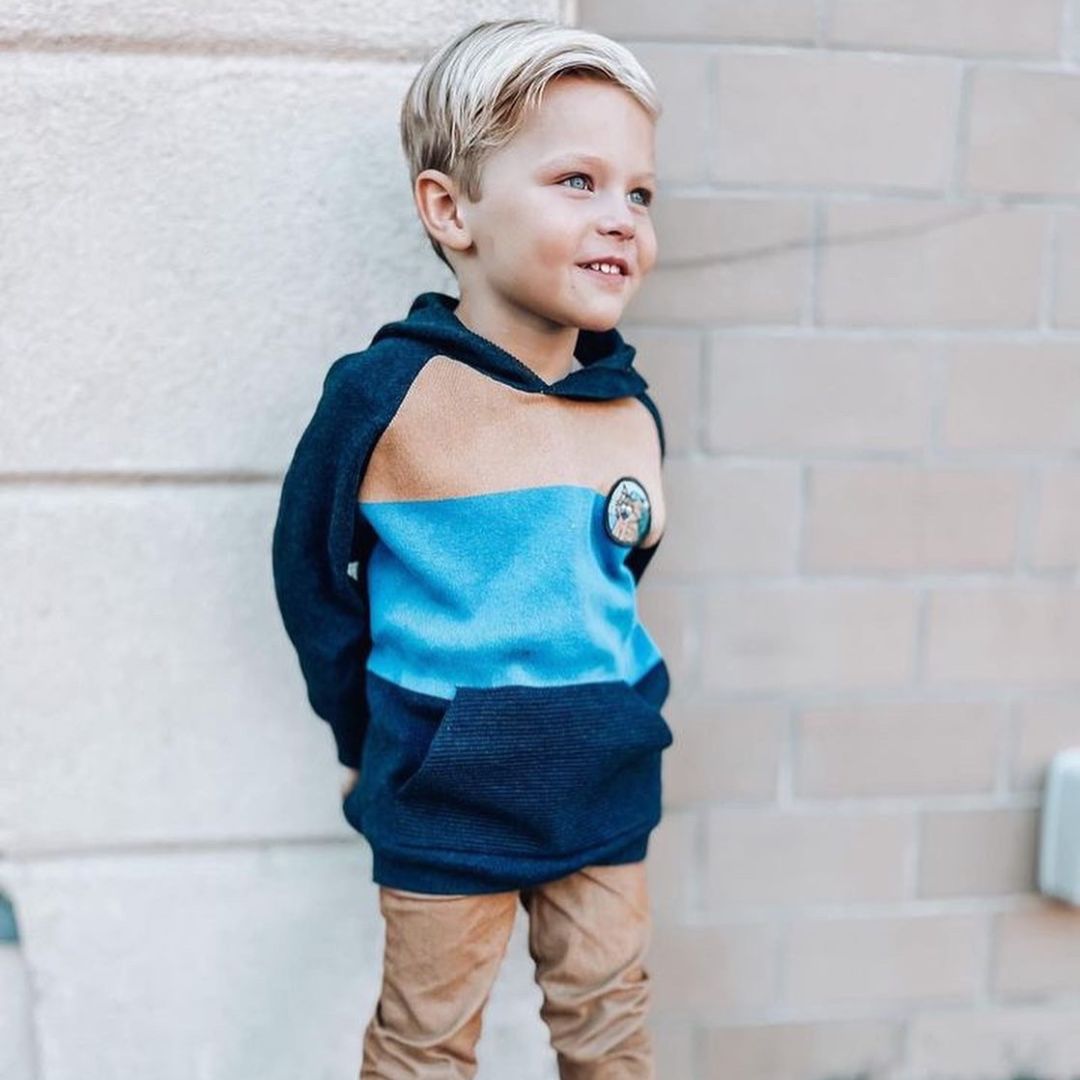 Cade in the city fauna knit hoodie and matching brown slim fit pants.