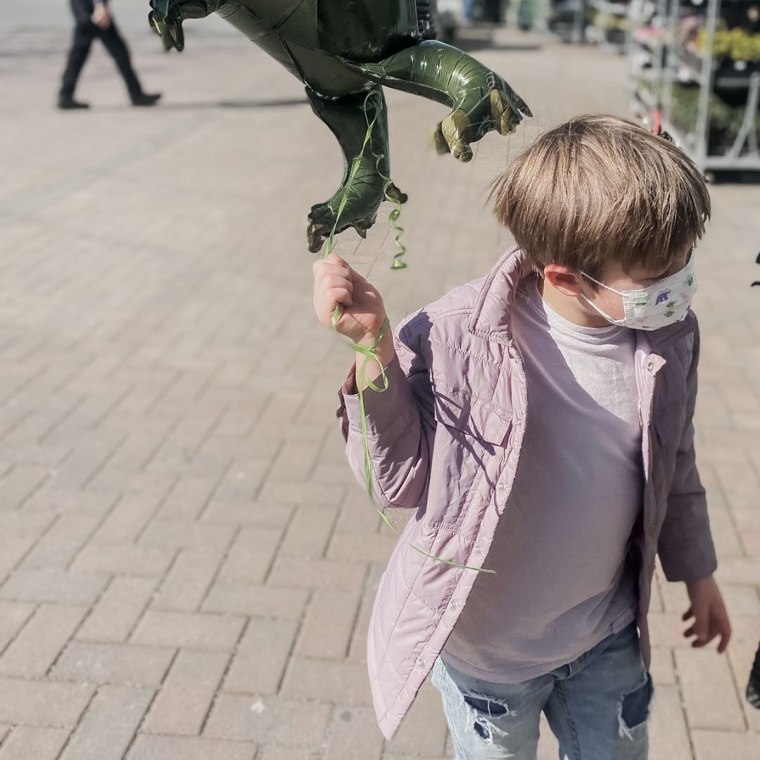 Boy holding a balloon wearing the Quilted Micro Canvas Jacket in Mist