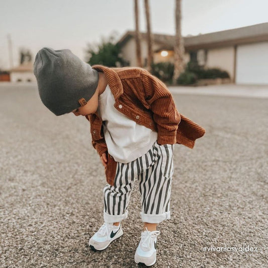 adorable toddler boy in a black and white outfit topped with the corduroy shacket.