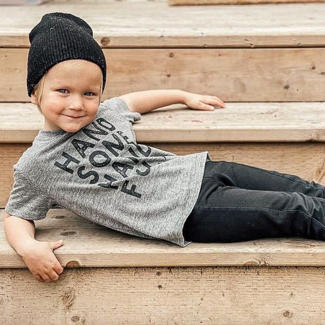 Boy on steps wearing the handsome handful shirt