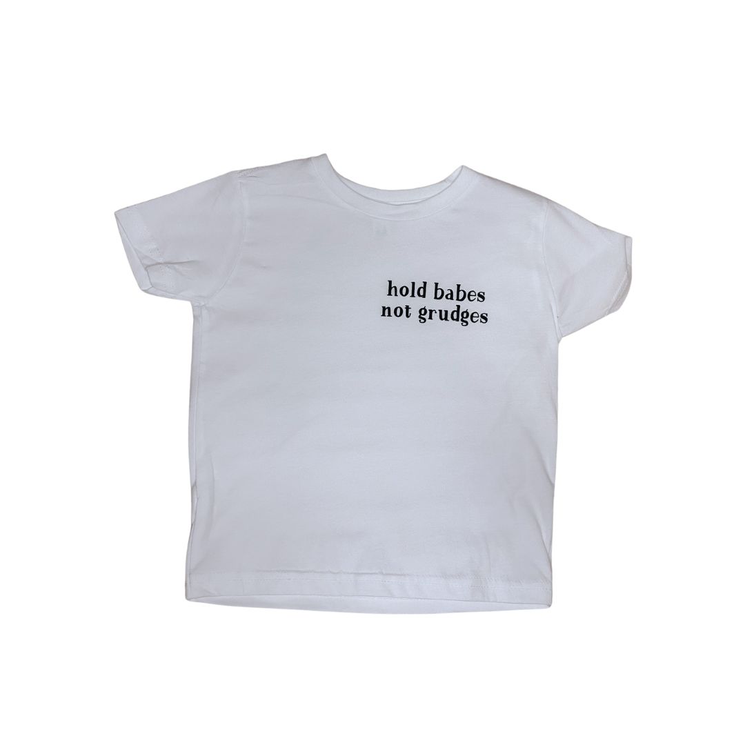 Flat lay of the "hold babes not grudges" shirt in white.
