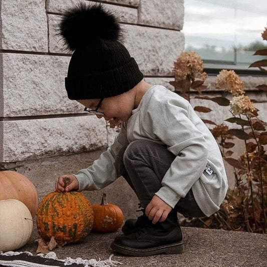 Boy with pumpkin wearing the raglan pullover in mint