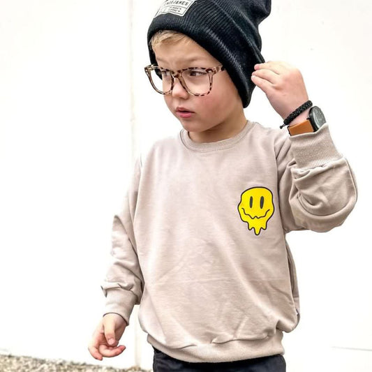 Rocco in the "have a good day" sweatshirt in fawn, glasses, and a matching beanie.