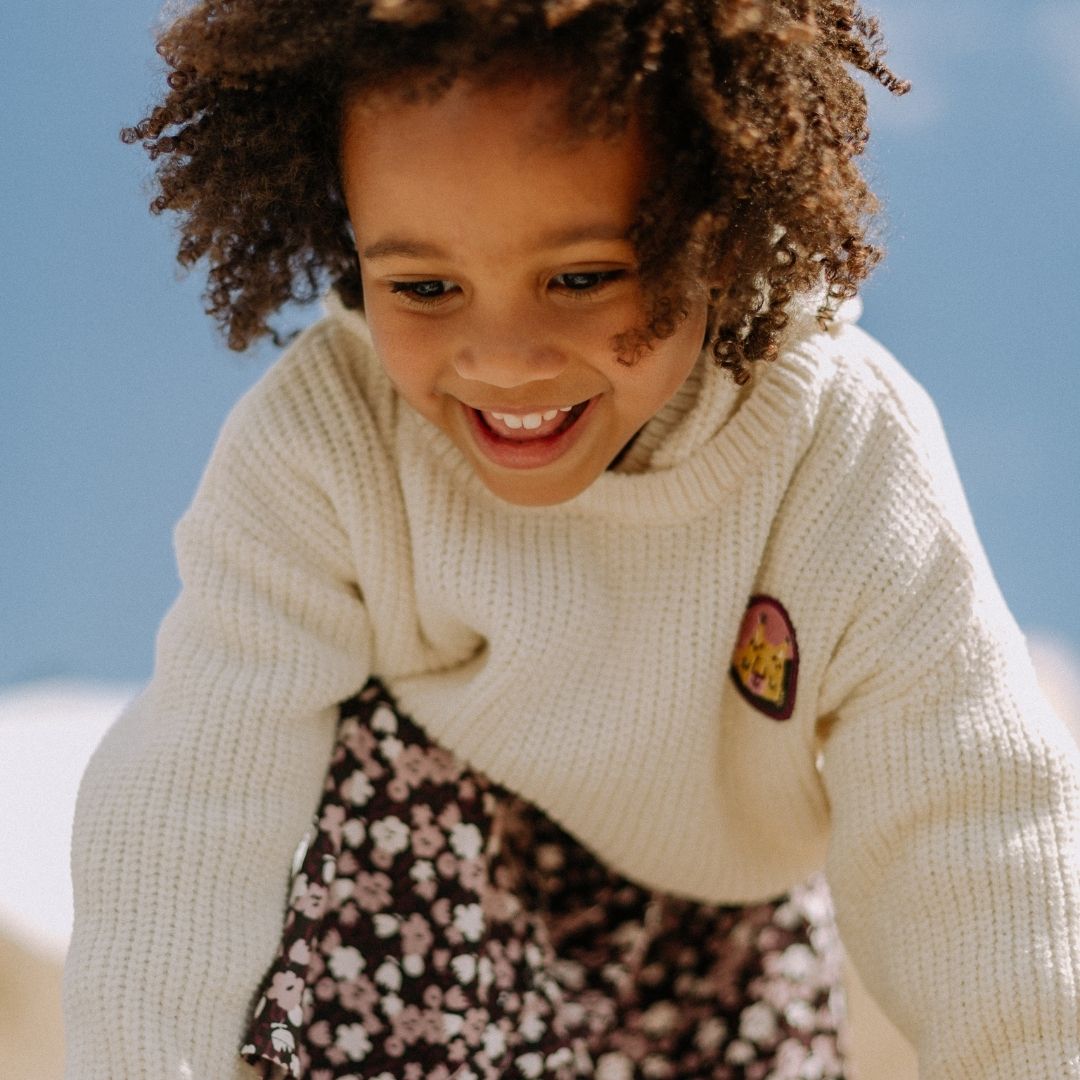Little girl in the Chenille hooded sweater in snow