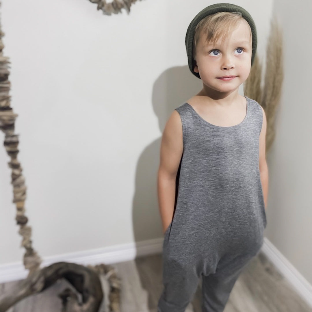 Four year old boy wearing the romper in heather grey and a green toque.