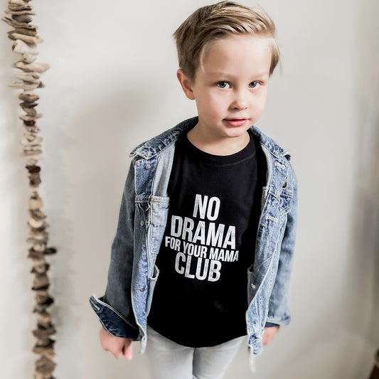 4 year old boy wearing the no drama for your mama club long sleeved shirt in black, blue denim jackets, and light grey jeans.